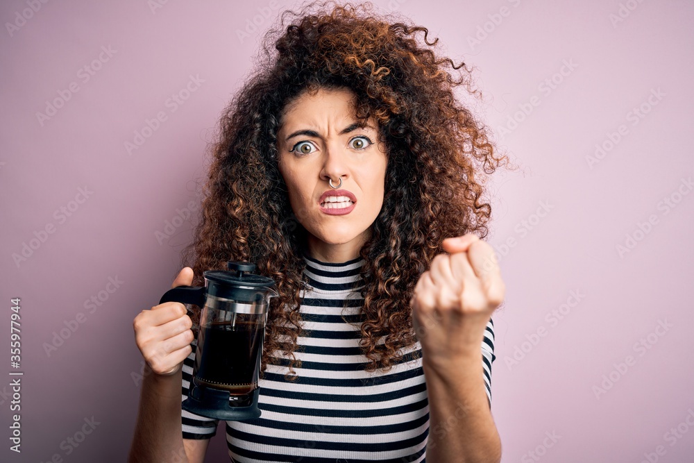 Young beautiful woman with curly hair and piercing doing coffee holding french coffeemaker annoyed and frustrated shouting with anger, crazy and yelling with raised hand, anger concept Young beautiful woman with curly hair and piercing doing coffee holding french coffeemaker annoyed and frustrated shouting with anger, crazy and yelling with raised hand, anger concept