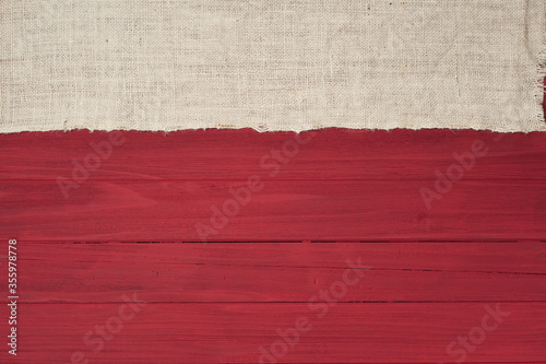 Rustic Red Wood Boards in Flat layout with off white Burlap fabric on top side as decorative design element. It's horizontal but works as vertical and has copy space.