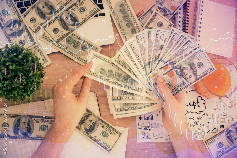 Multi exposure of financial graph drawing hologram and USA dollars bills and man hands. Analysis concept. Multi exposure of financial graph drawing hologram and USA dollars bills and man hands. Analysis concept.