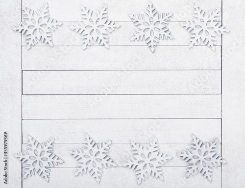 Christmas or New Years Snowflake Borders on White Wood Boards Background with copy space in the middle. It's horizontal but will work as Vertical.