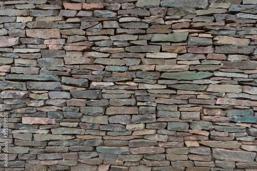 Decorative stone wall in various shades and sober colors  for background use.