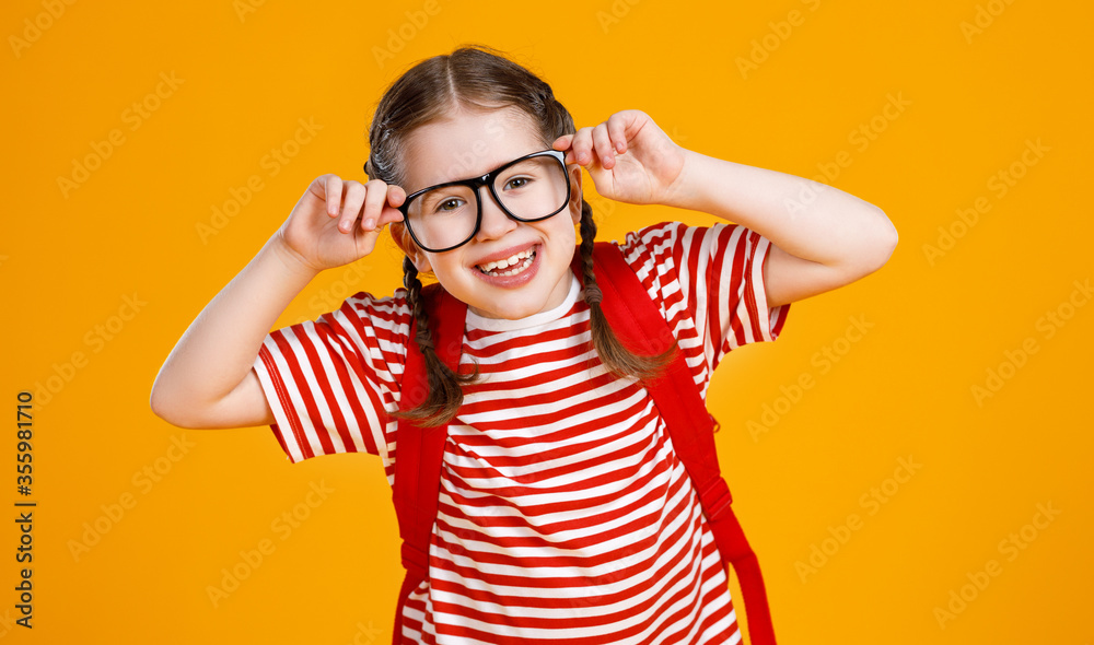 Cheerful smart schoolgirl adjusting glasses. Cheerful smart schoolgirl adjusting glasses.