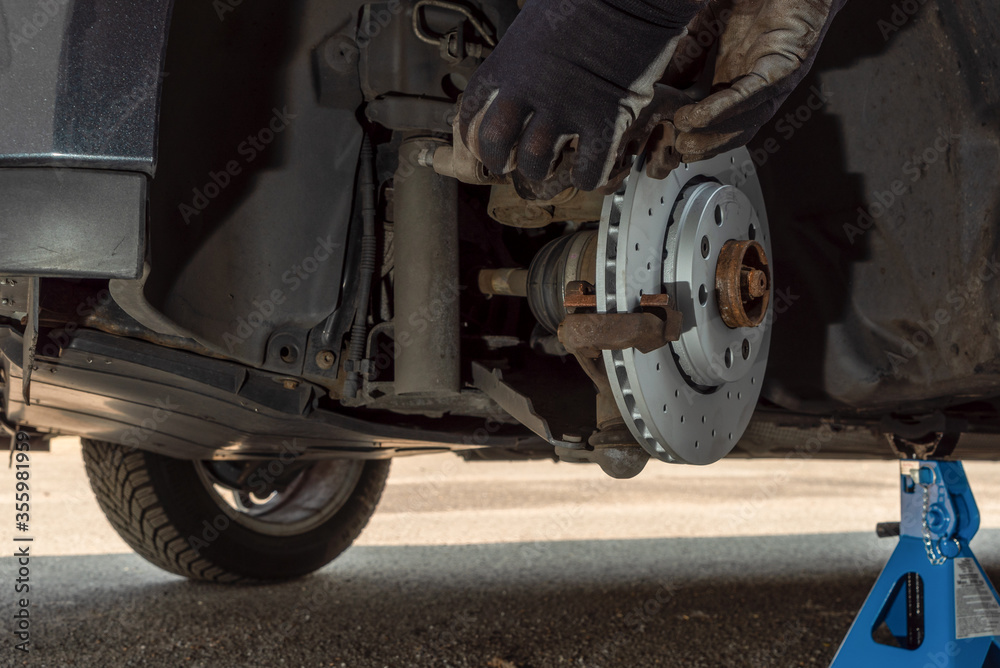Mechanic install car brake caliper Mechanic install car brake caliper