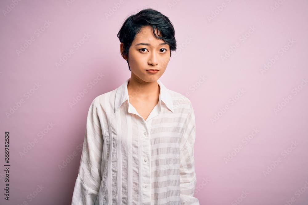 Young beautiful asian girl wearing casual shirt standing over isolated pink background looking sleepy and tired, exhausted for fatigue and hangover, lazy eyes in the morning. Young beautiful asian girl wearing casual shirt standing over isolated pink background looking sleepy and tired, exhausted for fatigue and hangover, lazy eyes in the morning.