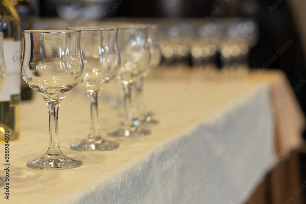 banquet hall table dinner time empty glasses for wine soft focus objects twilight romantic lighting
