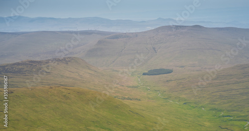 A wild stream between mountains brings life to nearby meadow - unspioled Scottish landscape