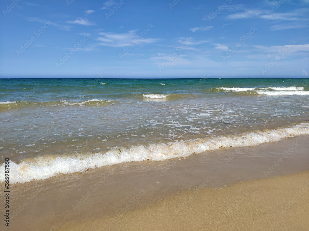 White waves runs on the yellow sand in sunny day White waves runs on the yellow sand in sunny day