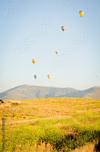 Balloon launch over field with mountains in background