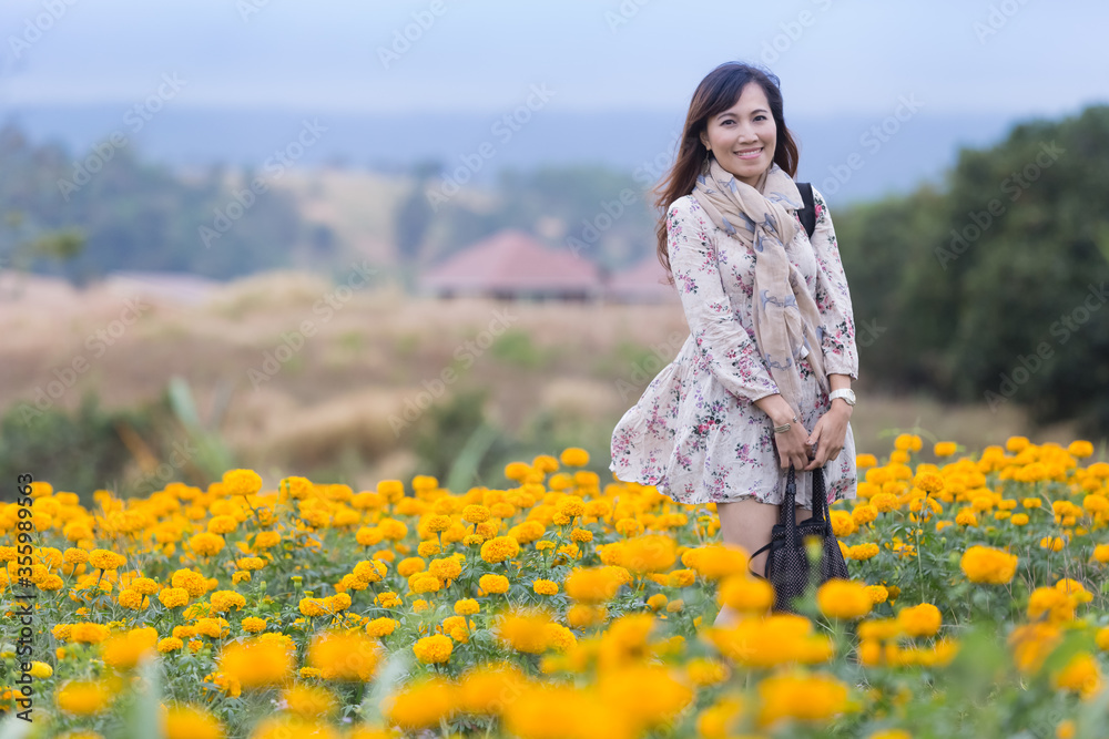 portrait of young pretty asian woman standing in a field of flowers during beautiful day in spring season portrait of young pretty asian woman standing in a field of flowers during beautiful day in spring season