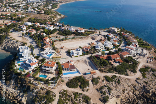 Cyprus, villas buildings on cliff for resort near Paphos city, aerial view. © DedMityay