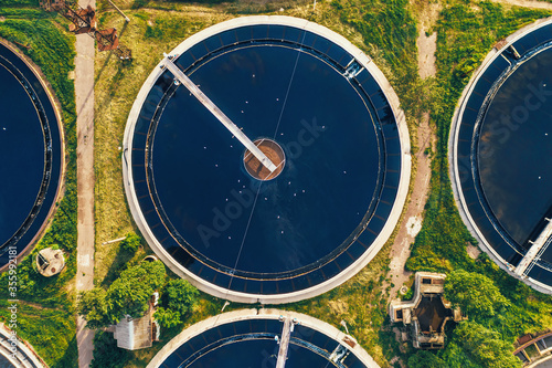 Aerial top view of round polls in wastewater treatment plant, filtration of dirty or sewage water.