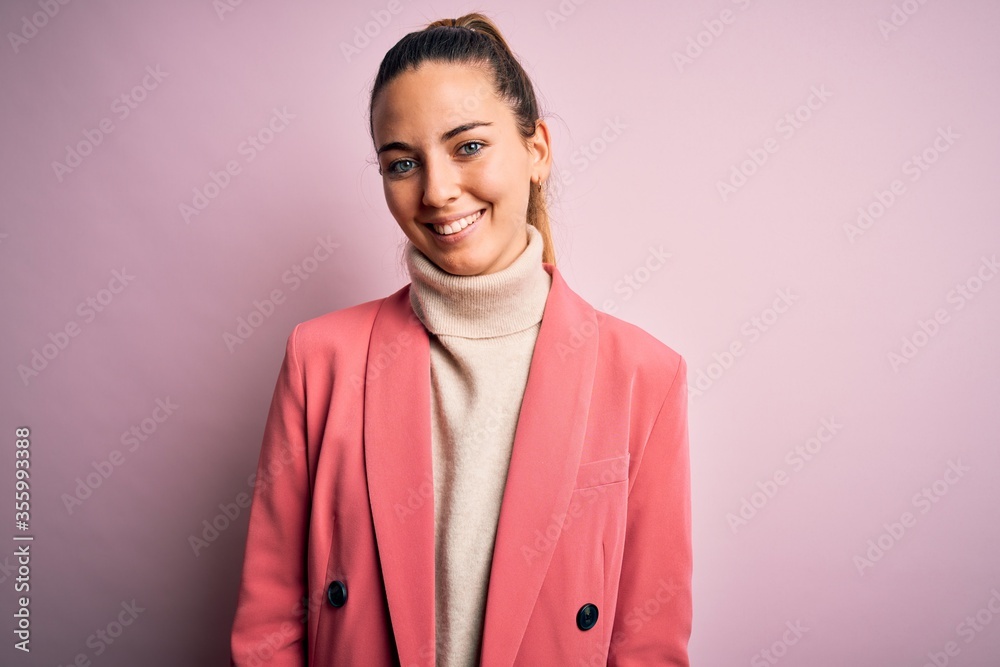 Young beautiful blonde businesswoman with blue eyes wearing elegant pink jacket with a happy and cool smile on face. Lucky person. Young beautiful blonde businesswoman with blue eyes wearing elegant pink jacket with a happy and cool smile on face. Lucky person.