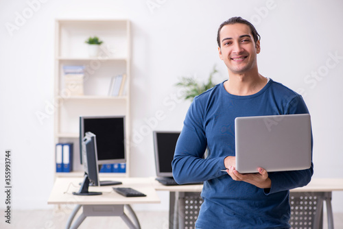 Young male it specialist working in the office photo