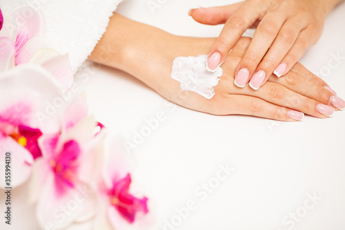 Woman applies moisturizer cream for hand skin care © Maksymiv Iurii