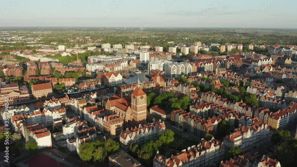 Aerial view of the historic center of the old city in Gdansk, Poland. Drone shot at an old building with red roofs and towers of the old city at sunset day. Aerial view of the historic center of the old city in Gdansk, Poland. Drone shot at an old building with red roofs and towers of the old city at sunset day.