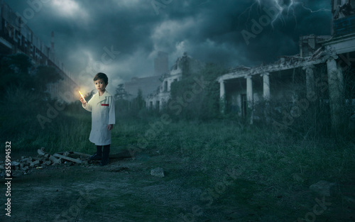 Scientist boy holding a syringe with the cure for the pandemic  Corona - Covid-19  in an apocalyptic scenario with destroyed buildings.