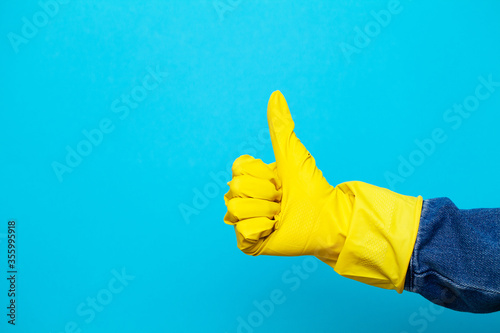 Hand in a yellow glove for cleaning