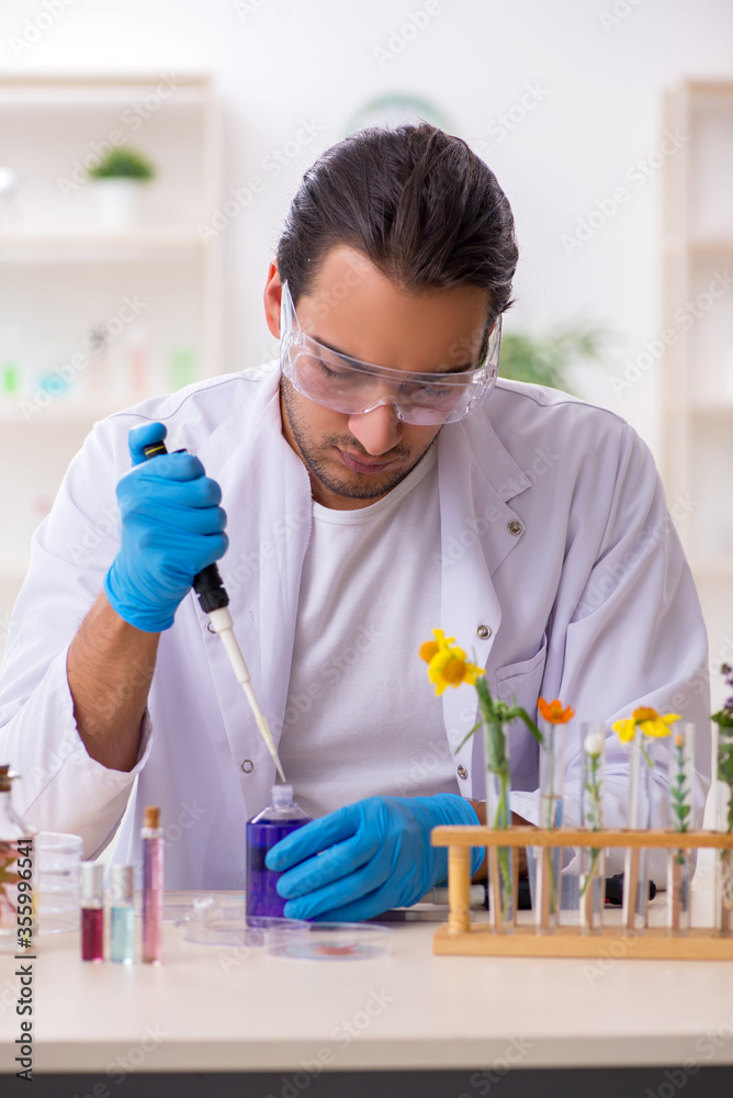 Young male chemist in perfume synthesis concept Young male chemist in perfume synthesis concept