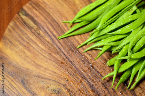 Cluster Bean or  GuarAlso Known as Gavar, Guwar or Guvar Bean isolated on Wooden Background