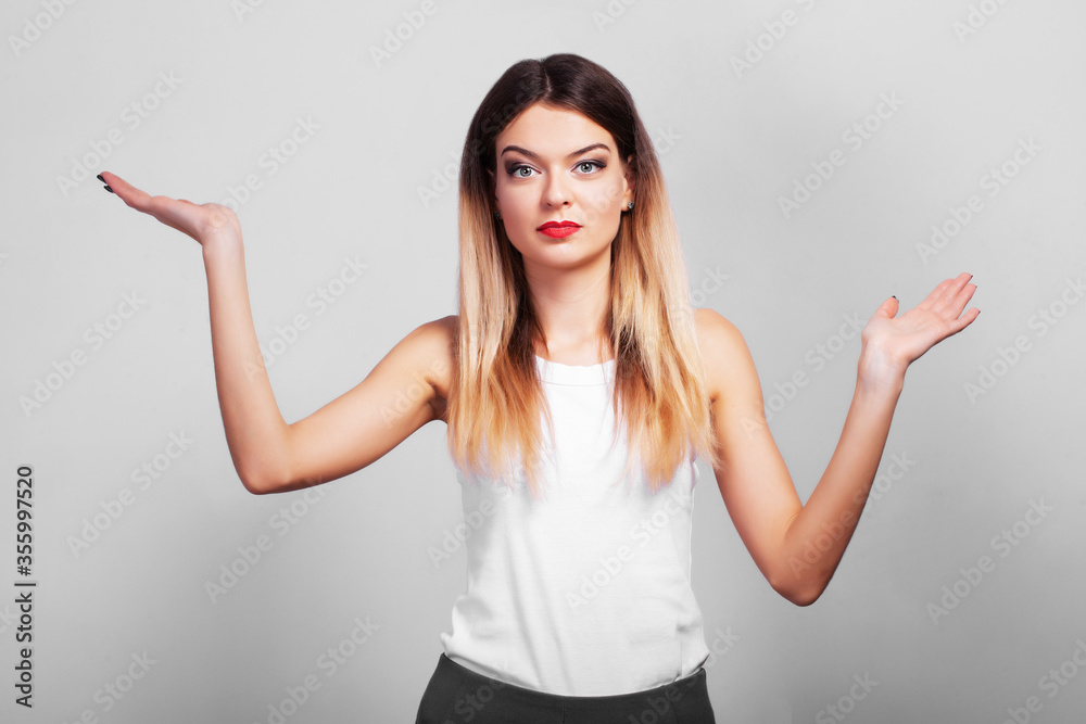 Surprised girl shows your product with her hand Surprised girl shows your product with her hand