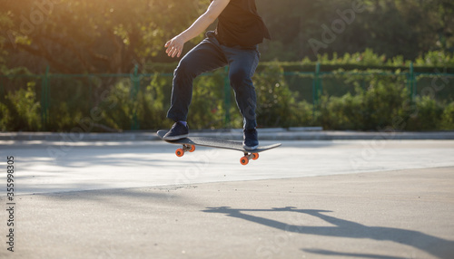 Fototapeta Naklejka Na Ścianę i Meble -  Skateboarder skateboarding at morning outdoors