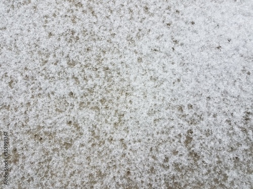white snow and ice on grey cement ground