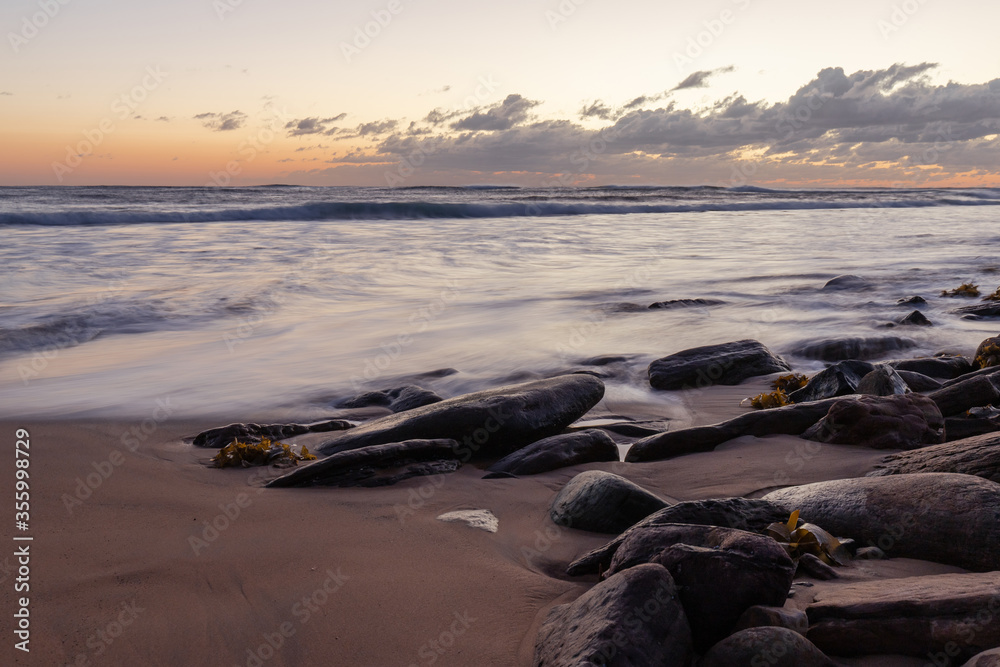Dawn view around the beach coastline with big rocks. Dawn view around the beach coastline with big rocks.