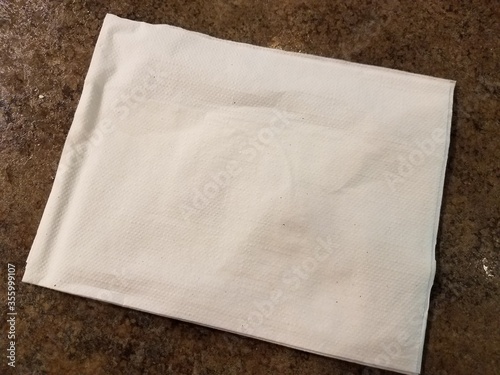 white napkin on a wet brown surface