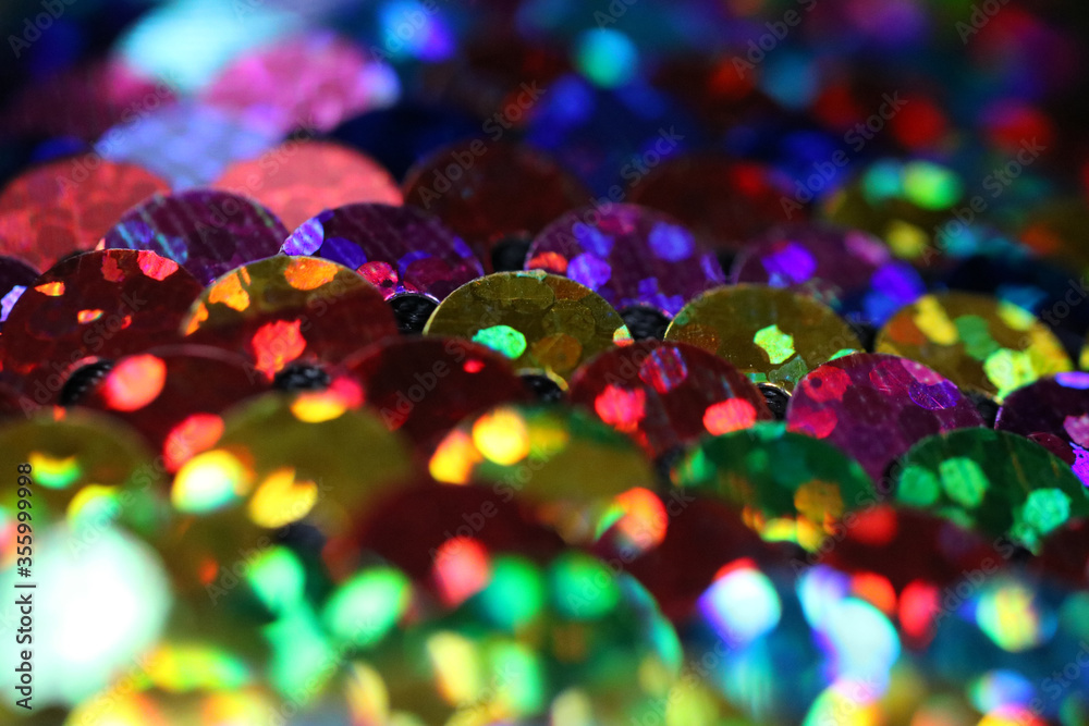 vibrant colorful rainbow sequins close up horizontal background with bokeh