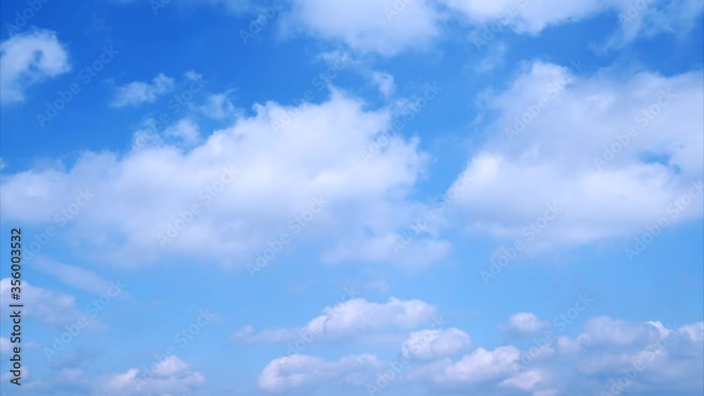 Low-angle shot of white clouds flowing in the blue sky, time-lapse Low-angle shot of white clouds flowing in the blue sky, time-lapse
