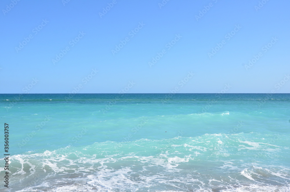 blue ocean water and waves at beach or coast