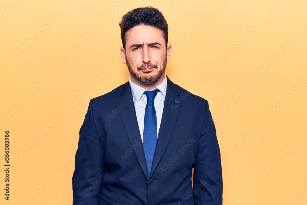Young hispanic man wearing suit skeptic and nervous, frowning upset because of problem. negative person. Young hispanic man wearing suit skeptic and nervous, frowning upset because of problem. negative person.