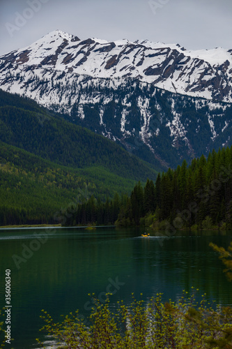 Kayaker on Stanton Lake and Great Northern Mountain  Montana