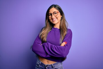 Young beautiful smart woman wearing glasses over purple isolated background happy face smiling with crossed arms looking at the camera. Positive person.