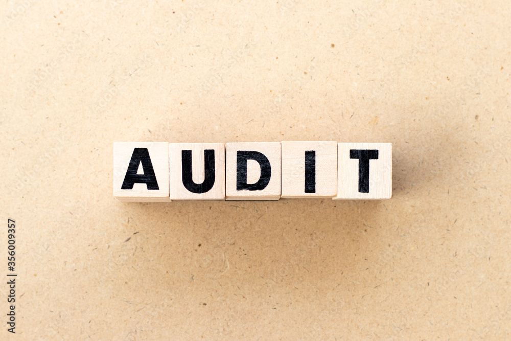 Fototapeta premium Letter block in word audit on wood background