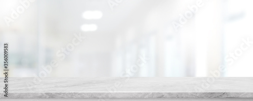Empty white marble stone table top and blur glass window interior lobby and hall way banner mock up abstract background - can used for display or montage your products.