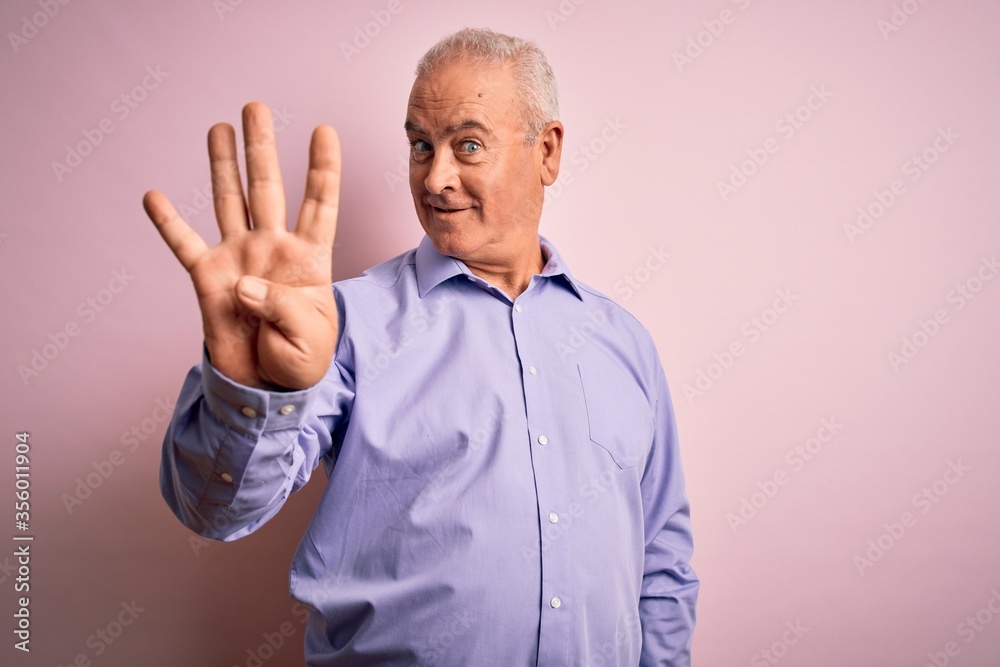 Middle age handsome hoary man wearing casual shirt standing over pink background showing and pointing up with fingers number four while smiling confident and happy. Middle age handsome hoary man wearing casual shirt standing over pink background showing and pointing up with fingers number four while smiling confident and happy.