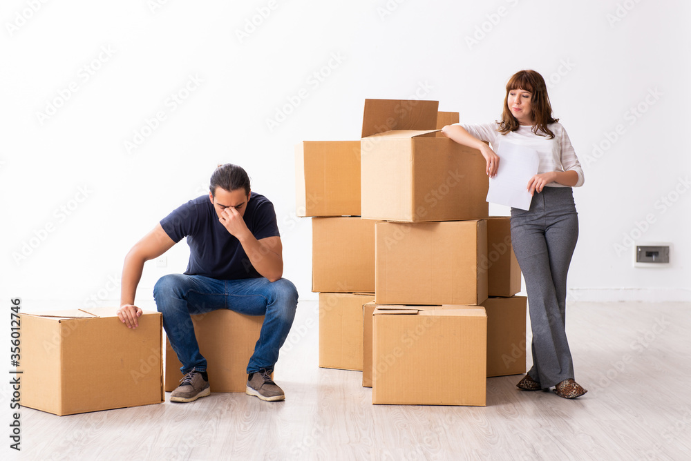 Young pair and many boxes in divorce settlement concept Young pair and many boxes in divorce settlement concept