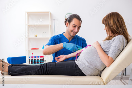 Young pregnant woman in blood transfusion concept