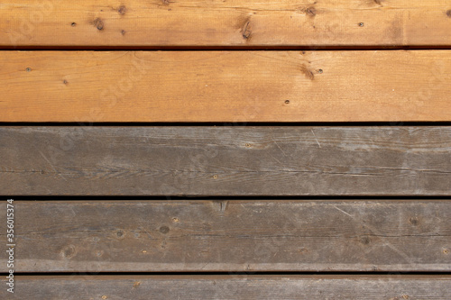 Close up abstract texture background of a cedar wood deck floor, showing new boards alongside older weathered boards, with copy space