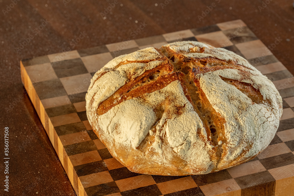 Sour dough bread on a checkerboard cutting board landscape Sour dough bread on a checkerboard cutting board landscape