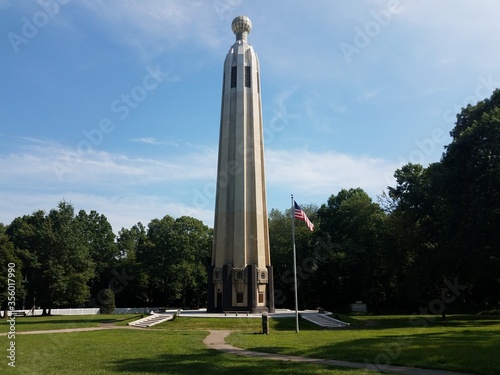 Vászonkép tall tower structure and flag of the United States of America