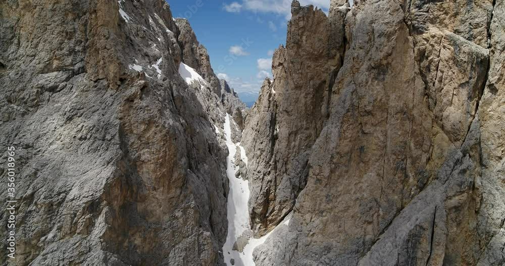 Aerial of narrow canyon in the Dolomites. Sassolungo Mountain Ethereal view 4K Aerial of narrow canyon in the Dolomites. Sassolungo Mountain Ethereal view 4K