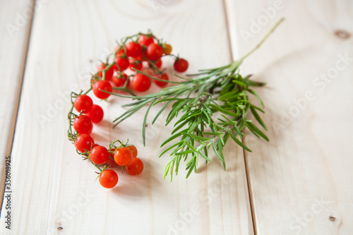 tomatoes and rosemary on a table, selective focus