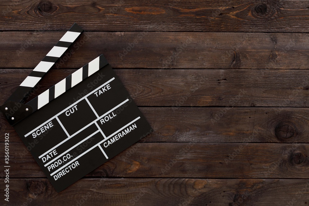 Filmmaking concept. Movie Clapperboard. Cinema begins with movie clappers. Movie clapper board on a wooden background.