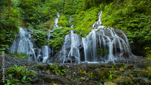 Waterfall landscape. Beautiful hidden waterfall in tropical rainforest. Nature background. Slow shutter speed  motion photography. Pucak Manik waterfall  Bali  Indonesia