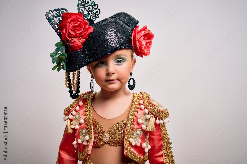 Young little caucasian kid girl wearing bullfighter traditional folkore spanish suit as carnival costume standing over isolated background Young little caucasian kid girl wearing bullfighter traditional folkore spanish suit as carnival costume standing over isolated background