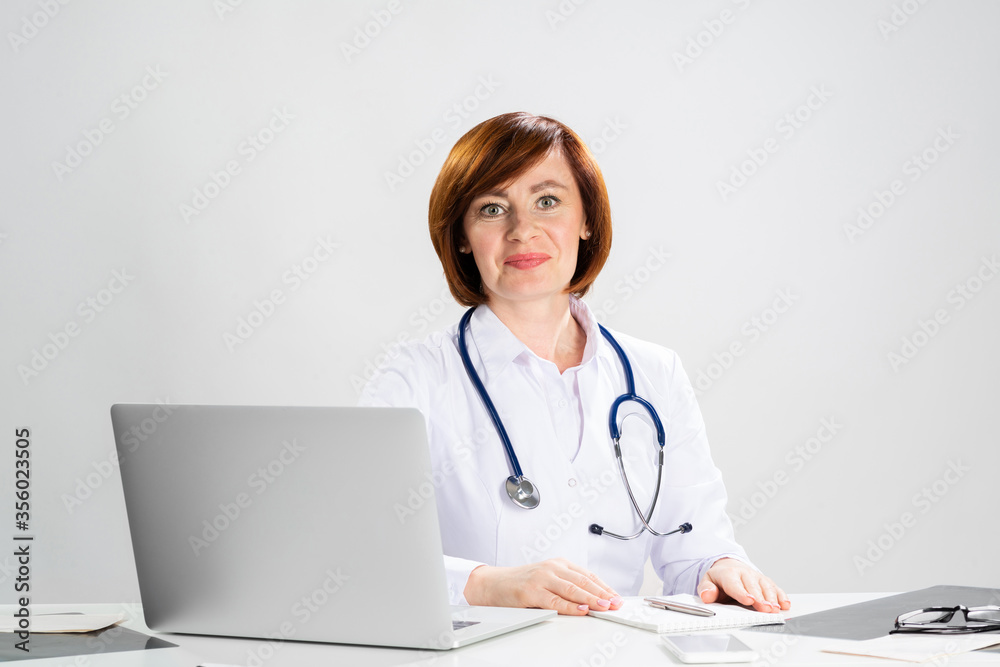 Family physician in white coat with stethoscope Family physician in white coat with stethoscope