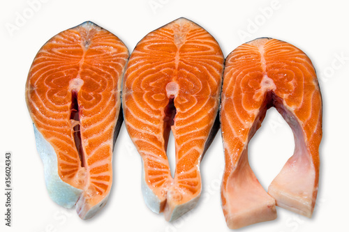 Large pieces of fresh salmon steak are isolated on a white background