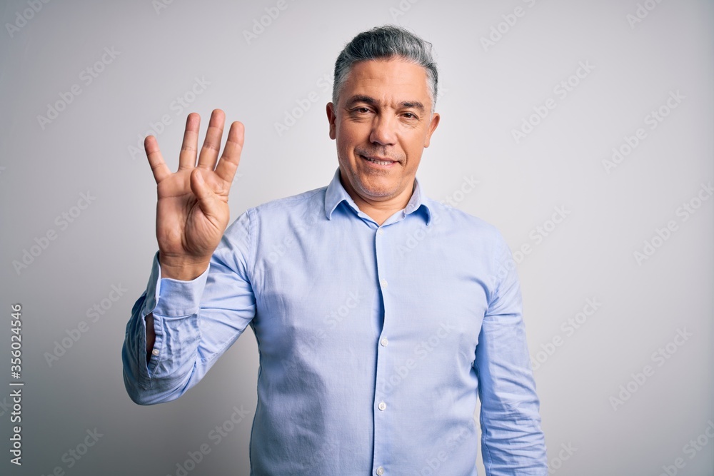 Middle age handsome grey-haired business man wearing elegant shirt over white background showing and pointing up with fingers number four while smiling confident and happy.